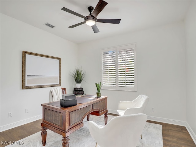 home office with ceiling fan and dark hardwood / wood-style floors