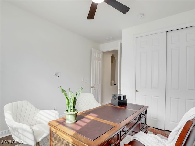 home office with wood-type flooring and ceiling fan