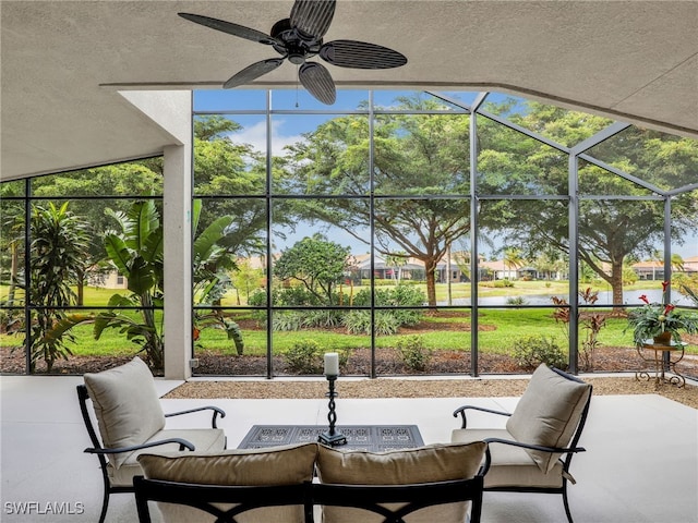 sunroom / solarium featuring ceiling fan