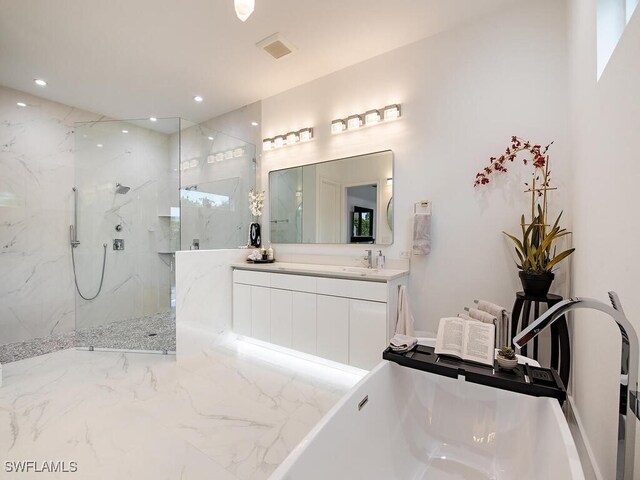 bathroom featuring vanity and separate shower and tub