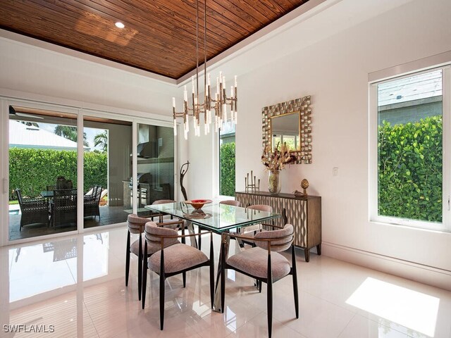 tiled dining area with wooden ceiling, an inviting chandelier, and a tray ceiling