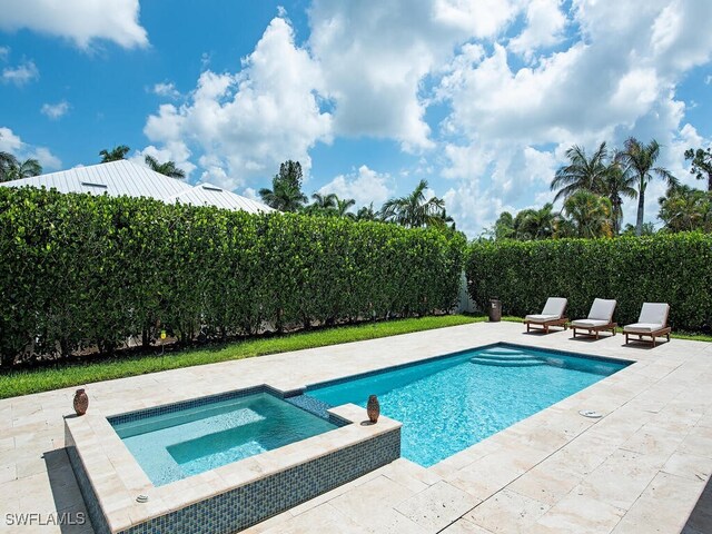 view of swimming pool with an in ground hot tub and a patio