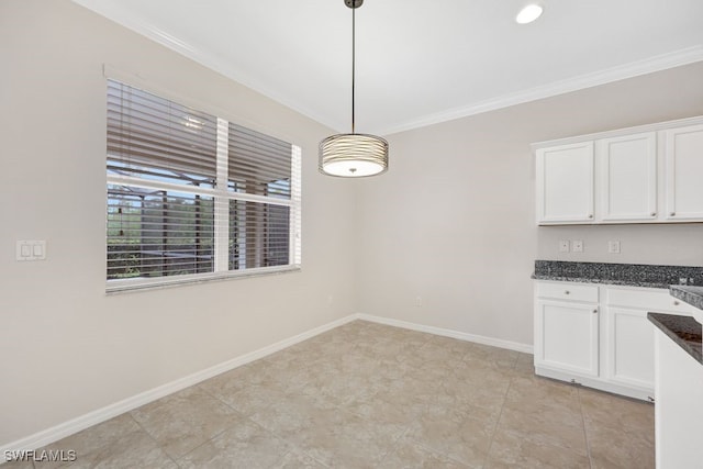 kitchen featuring light tile patterned floors, crown molding, hanging light fixtures, and white cabinetry