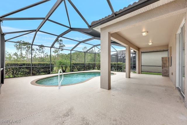 view of pool with a lanai and a patio