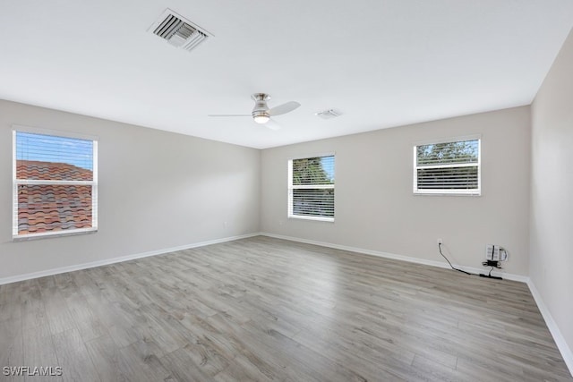 empty room featuring ceiling fan and light hardwood / wood-style flooring