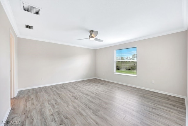 spare room with ceiling fan, hardwood / wood-style flooring, and crown molding