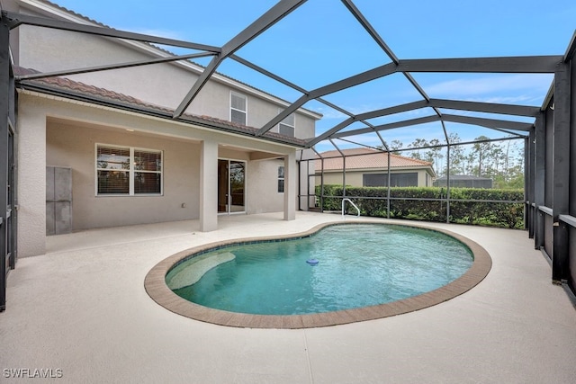 view of swimming pool with a patio and a lanai