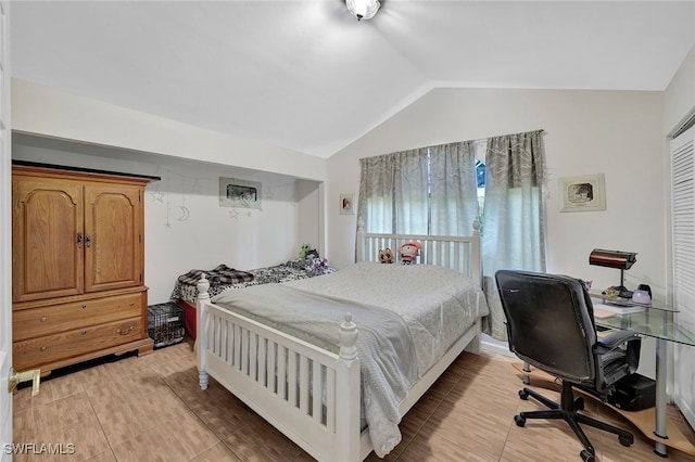 bedroom featuring light wood-type flooring and lofted ceiling