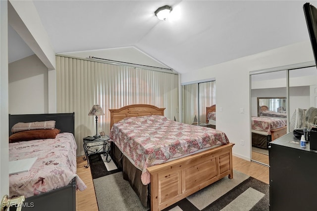 bedroom featuring vaulted ceiling and light hardwood / wood-style floors