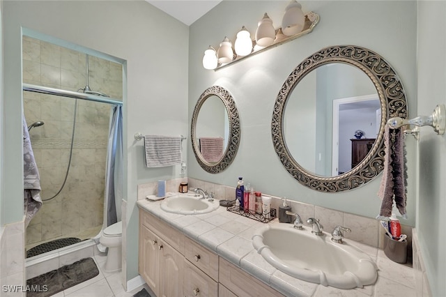 bathroom featuring double sink vanity, walk in shower, toilet, and tile patterned floors