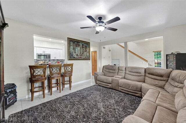 living room with ceiling fan and light tile patterned floors