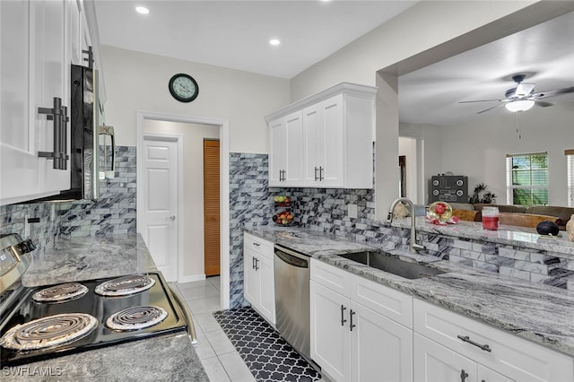 kitchen featuring ceiling fan, light tile patterned flooring, tasteful backsplash, and sink