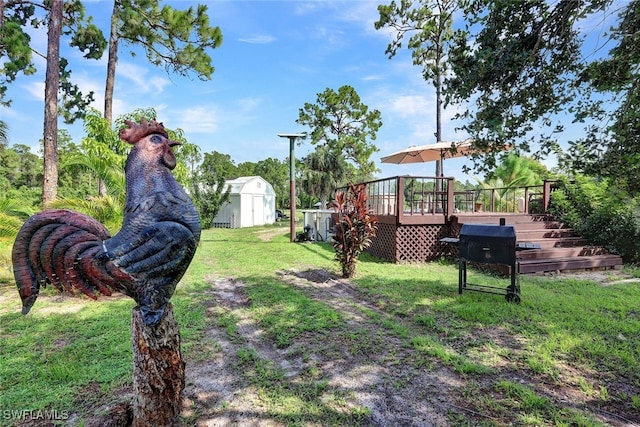 view of yard featuring a storage shed and a wooden deck