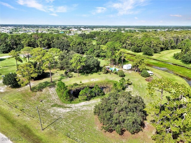 birds eye view of property featuring a wooded view