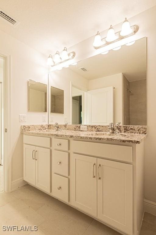 bathroom featuring tile patterned flooring and vanity