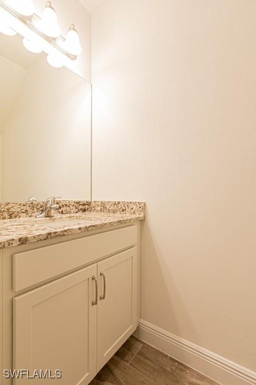 bathroom with hardwood / wood-style floors and vanity