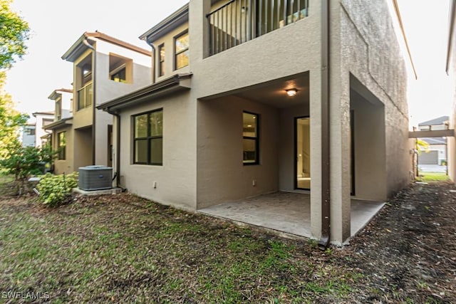 rear view of house with a patio and central AC