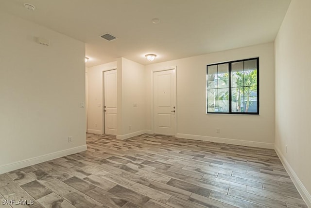 spare room featuring light wood-type flooring