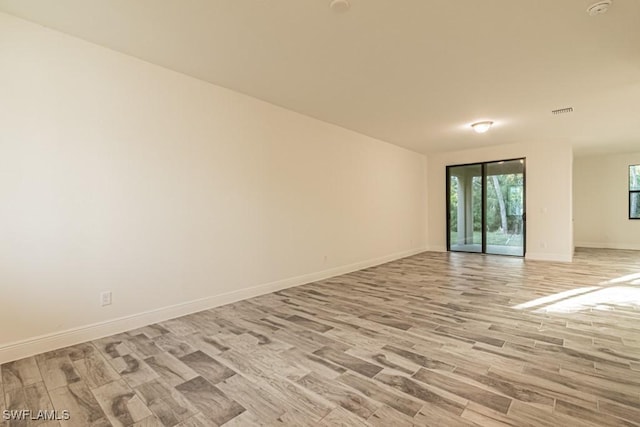 unfurnished room with light hardwood / wood-style floors