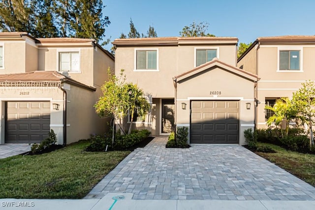 view of front of property with a garage and a front lawn