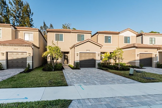 view of front of house with a garage and a front yard