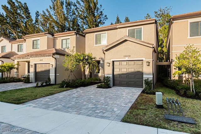 view of front of house with a garage and a front lawn