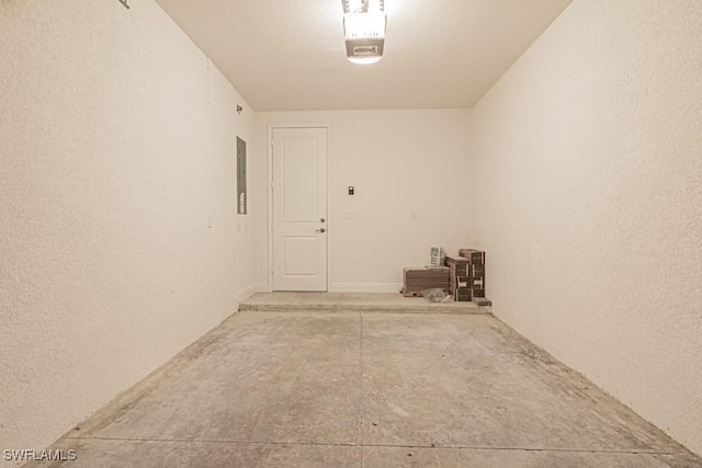 garage with electric panel and a garage door opener