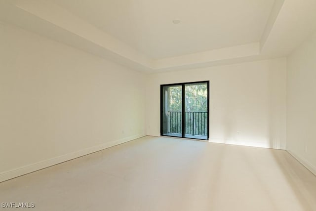 empty room featuring a raised ceiling