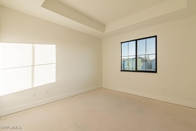 unfurnished room with a raised ceiling