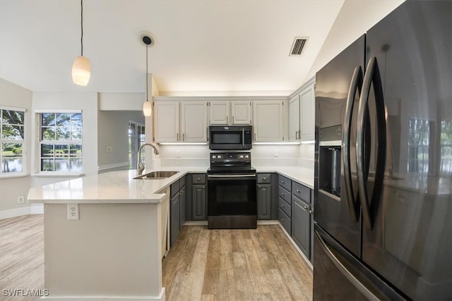 kitchen with kitchen peninsula, black appliances, pendant lighting, gray cabinetry, and sink