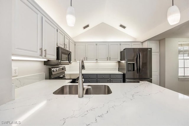 19666 Lost Creek Dr, Estero, FL 33967 - kitchen featuring appliances with stainless steel finishes, a sink, lofted ceiling, light stone counters, and pendant lighting