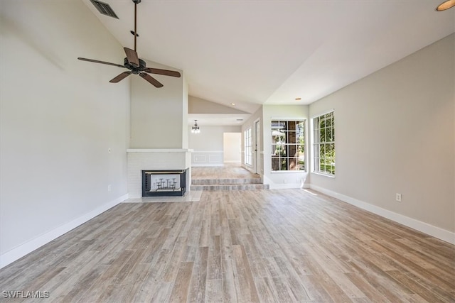 unfurnished living room featuring high vaulted ceiling, a fireplace, light hardwood / wood-style floors, and ceiling fan