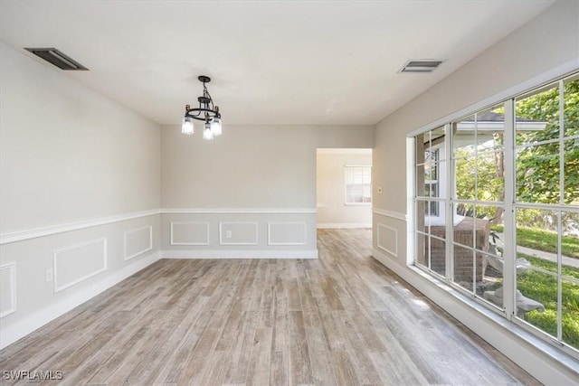 19666 Lost Creek Dr, Estero, FL 33967 - spare room featuring a chandelier and light wood-style floors