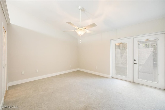 carpeted empty room featuring french doors and ceiling fan