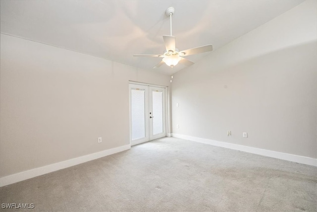 spare room with french doors, carpet flooring, vaulted ceiling, and ceiling fan