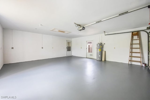 garage featuring a garage door opener and water heater