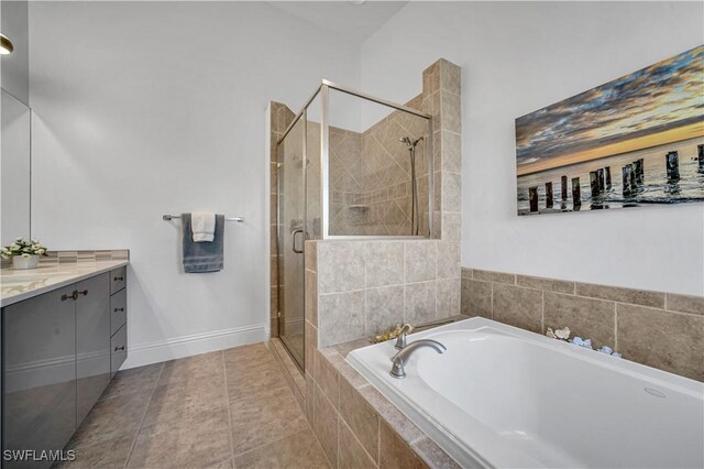 bathroom with tile patterned floors, independent shower and bath, and vanity