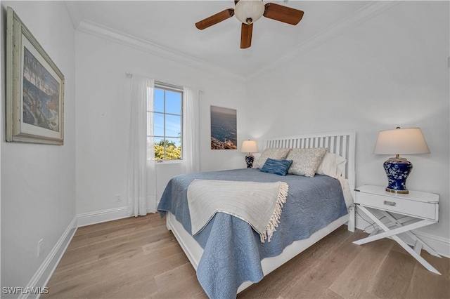 bedroom with hardwood / wood-style flooring, ceiling fan, and crown molding