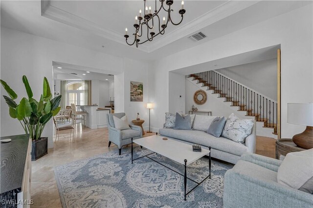 tiled living room with a tray ceiling and a chandelier