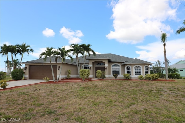 ranch-style home featuring a garage and a front lawn