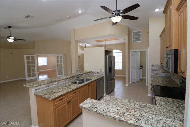 kitchen with light tile patterned flooring, ceiling fan, stainless steel appliances, sink, and backsplash