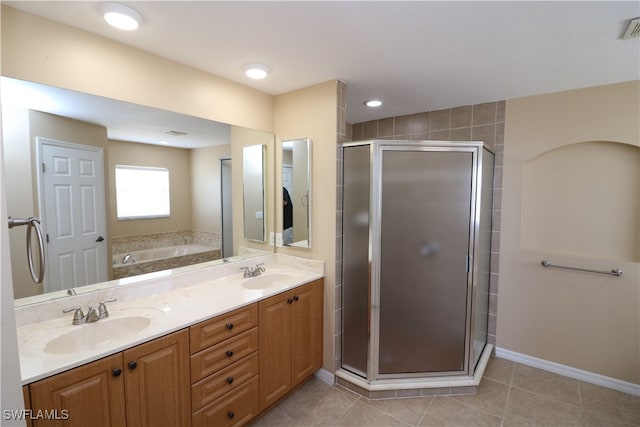 bathroom with tile patterned floors, double sink vanity, and a shower with door