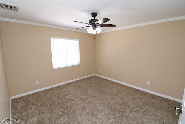 spare room with ornamental molding, carpet floors, and ceiling fan