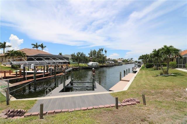 view of dock featuring a water view and a yard