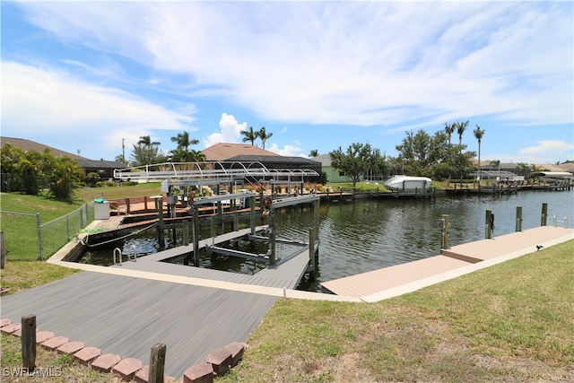 dock area with a yard and a water view