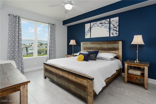 bedroom with ceiling fan and baseboards