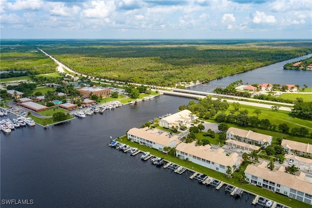 aerial view with a water view and a forest view