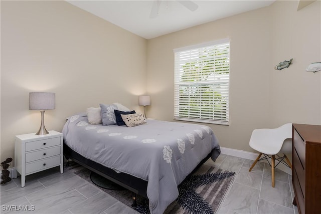 bedroom featuring ceiling fan and baseboards