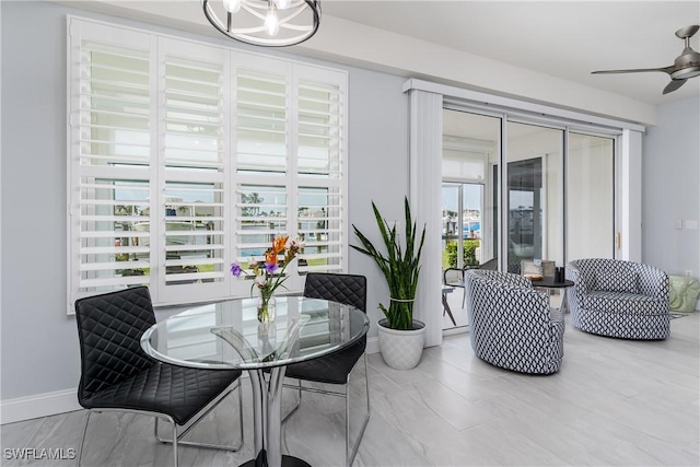 dining room with baseboards and a ceiling fan