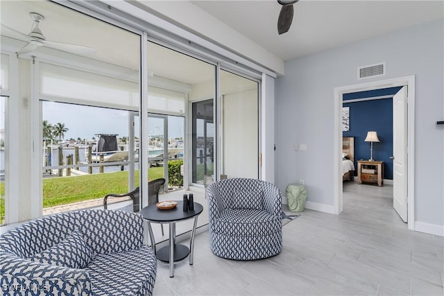 sunroom featuring ceiling fan and visible vents